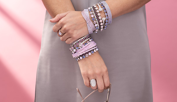 Woman wearing pink and purple crystal bracelets